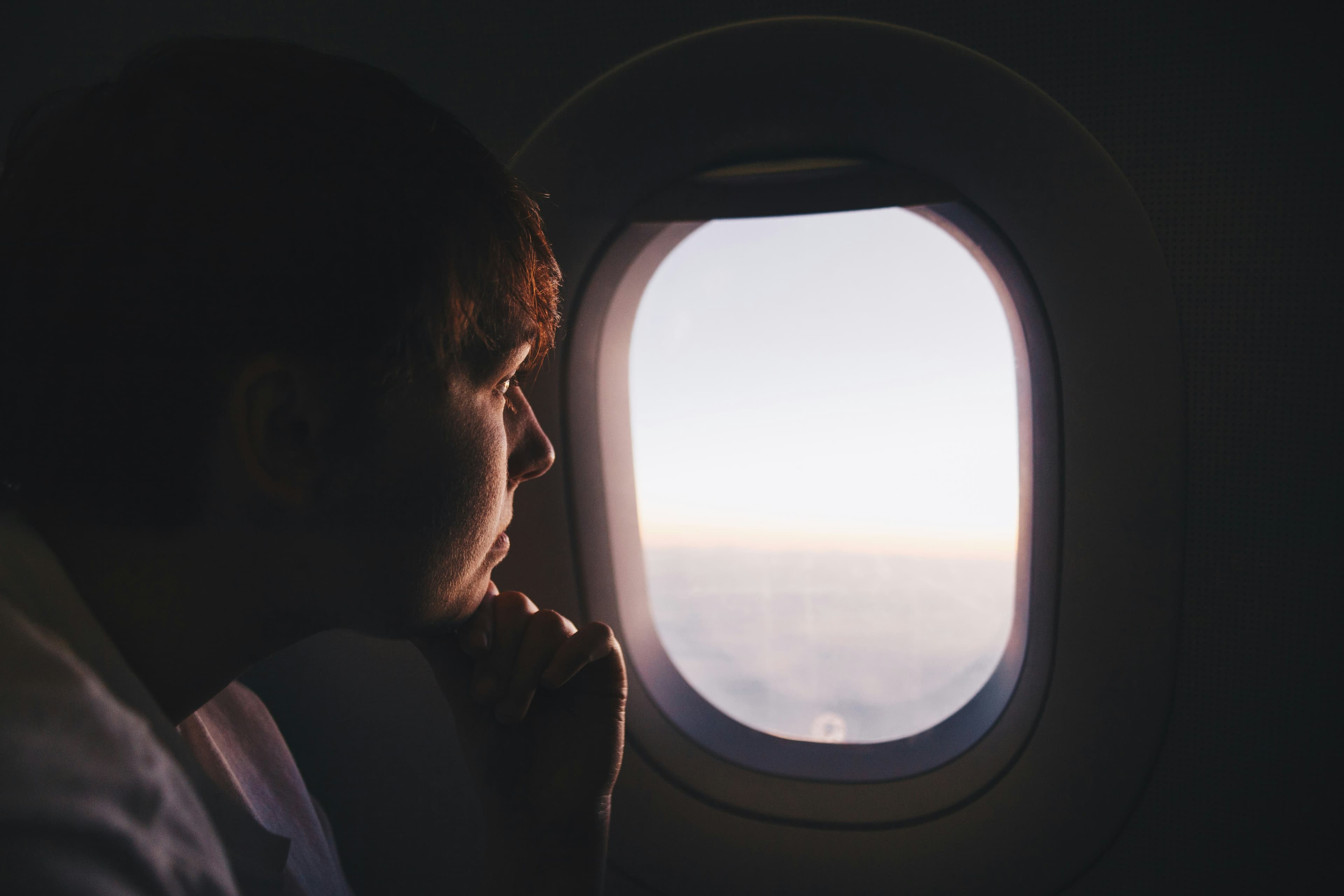 Man looking out of an airplane window